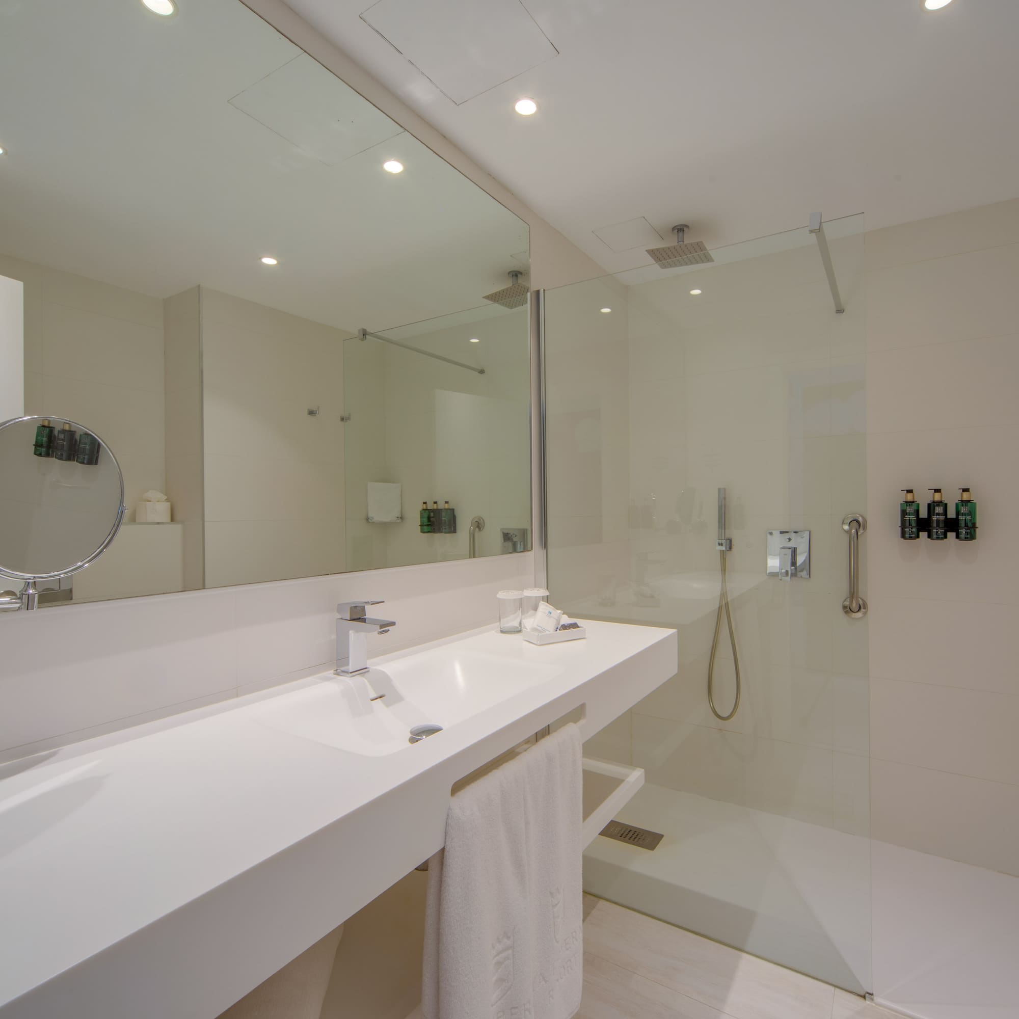 a bathroom with a glass shower and sink