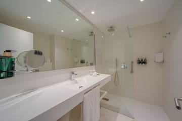 a bathroom with a glass shower and sink
