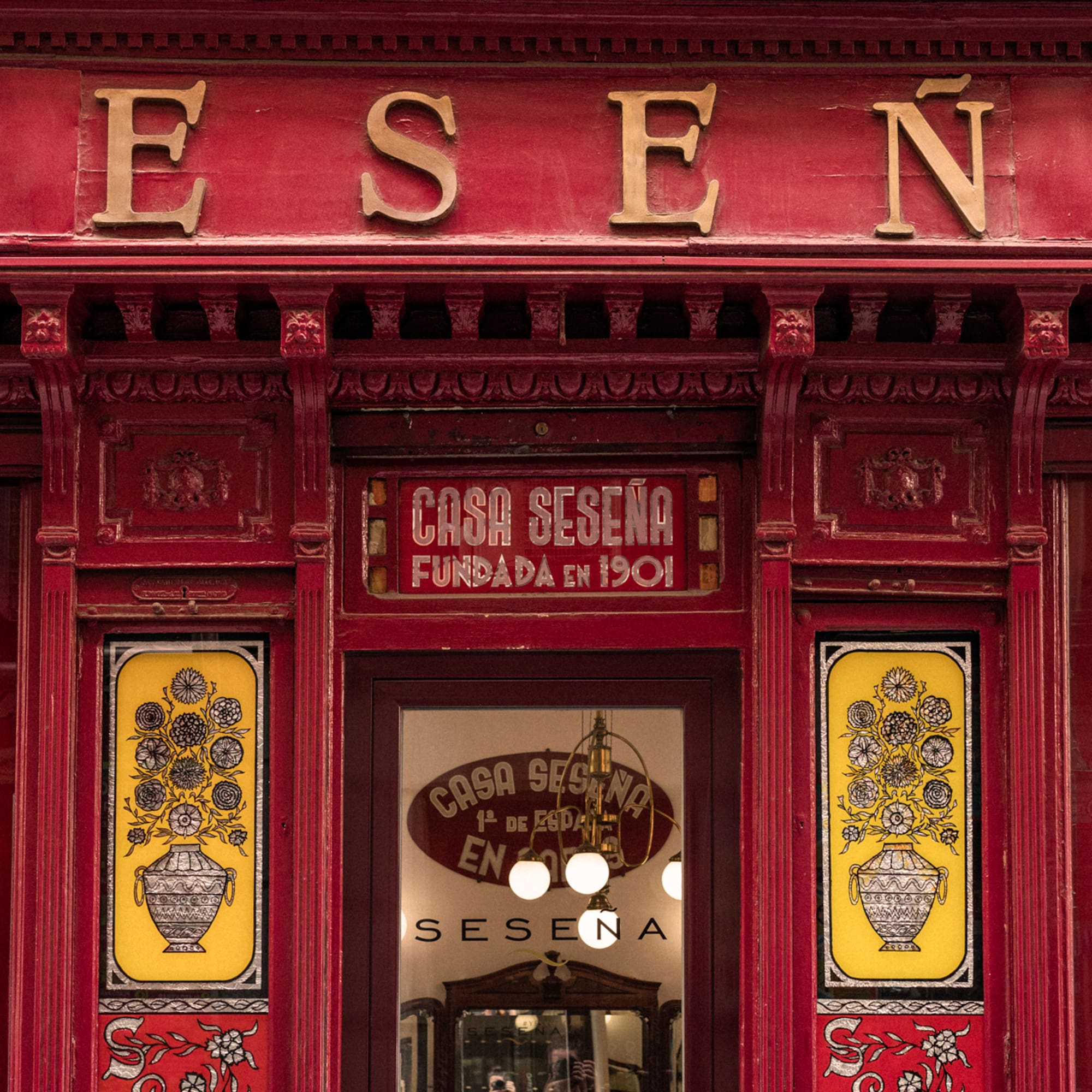 a red store front with yellow and red signs
