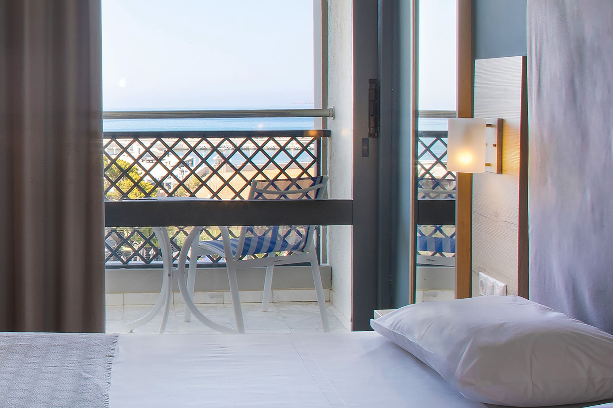 a room with a balcony and a bed