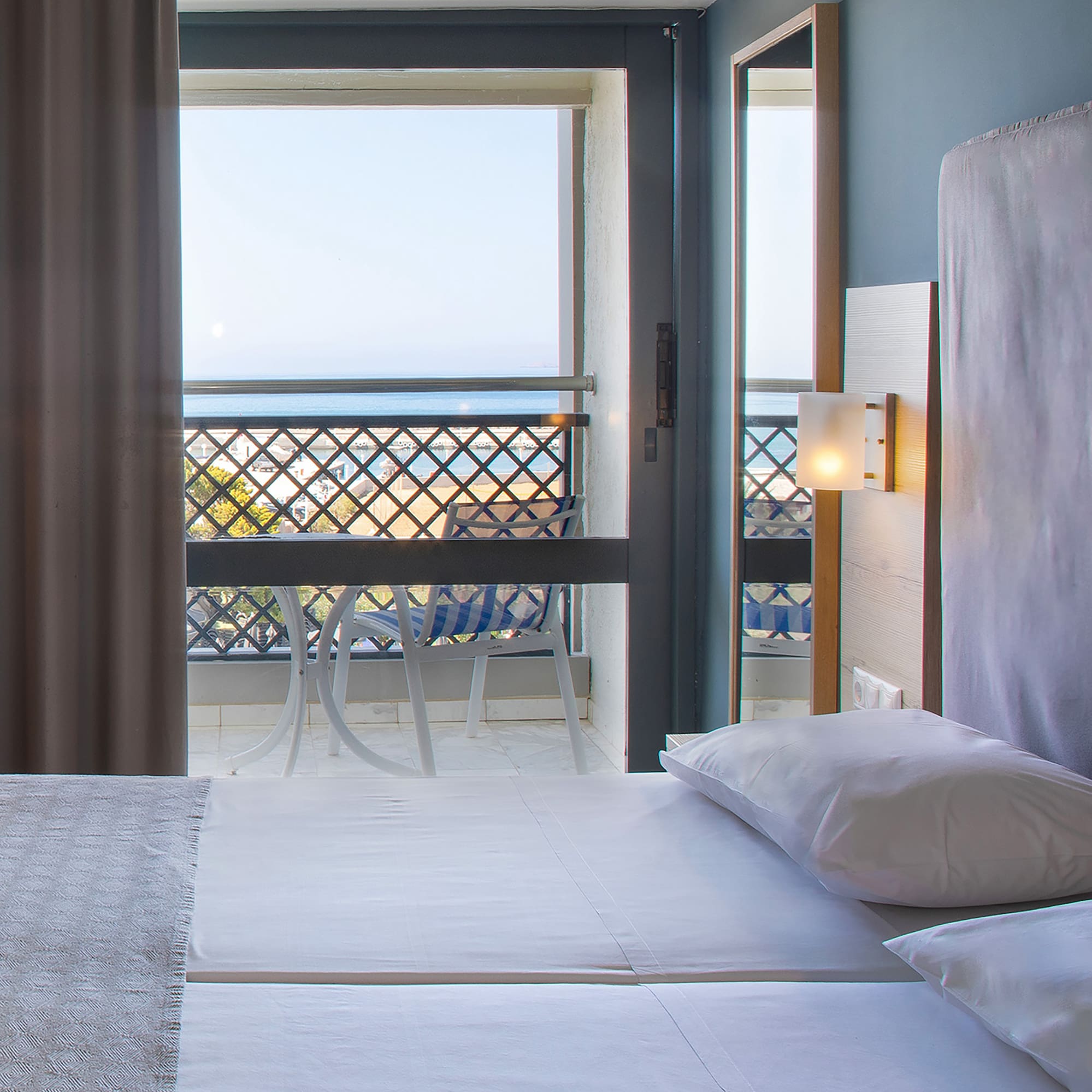 a room with a balcony and a bed