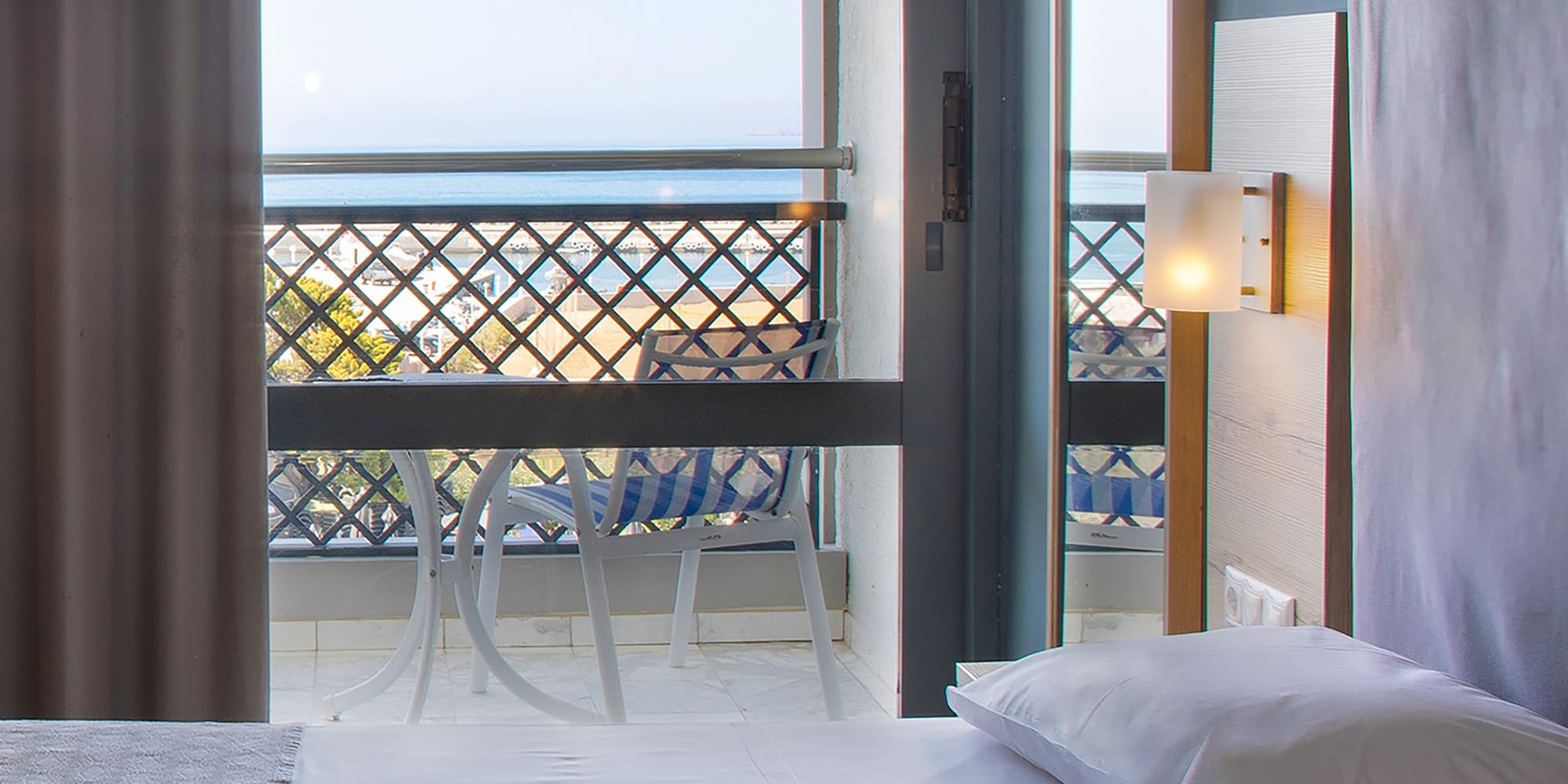 a room with a balcony and a bed