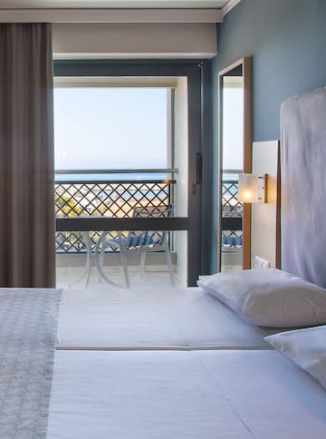 a room with a balcony and a bed