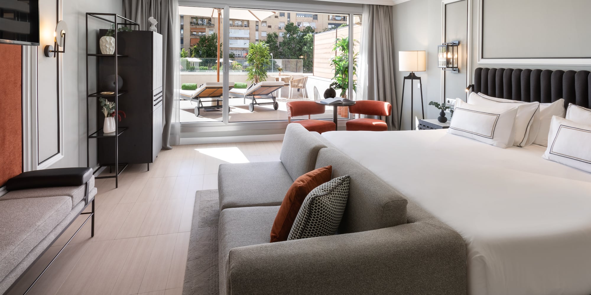 a bedroom with a large bed and a couch