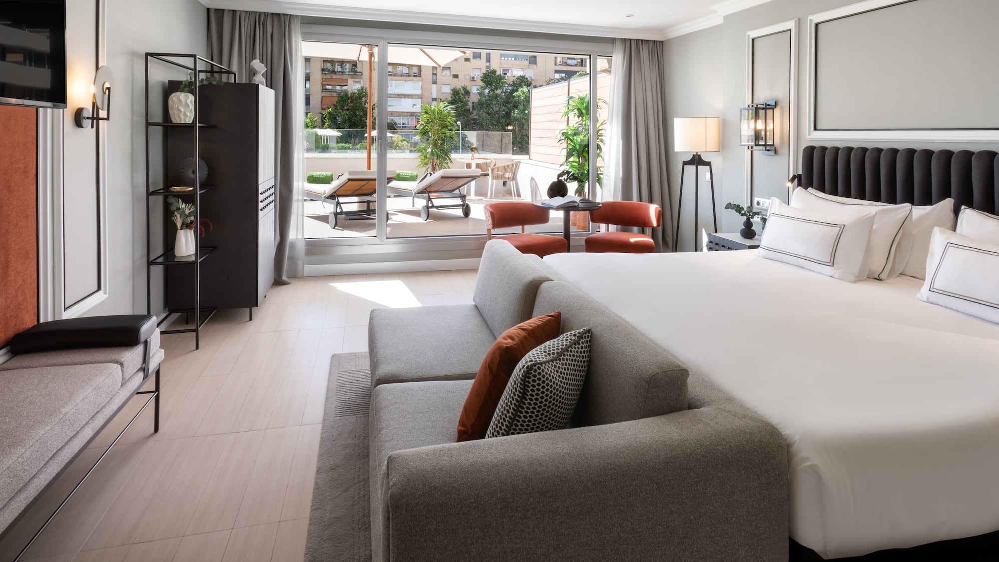 a bedroom with a large bed and a couch