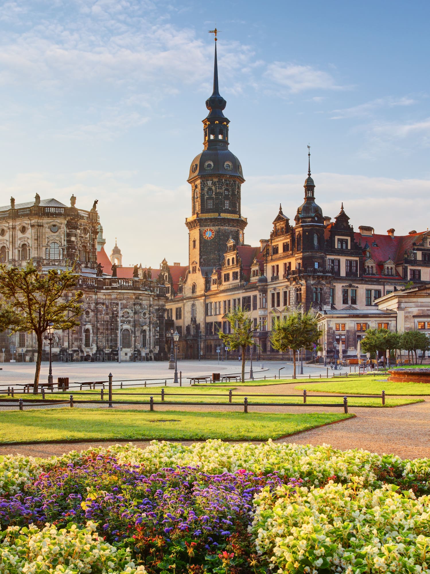 Dresden Hofkirche and Residenzschloss overlooking vibrant flower gardens.