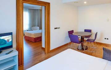 a room with a table and purple chairs