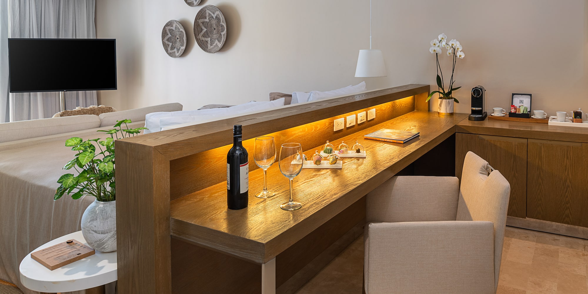 a table with wine glasses and a bottle on it