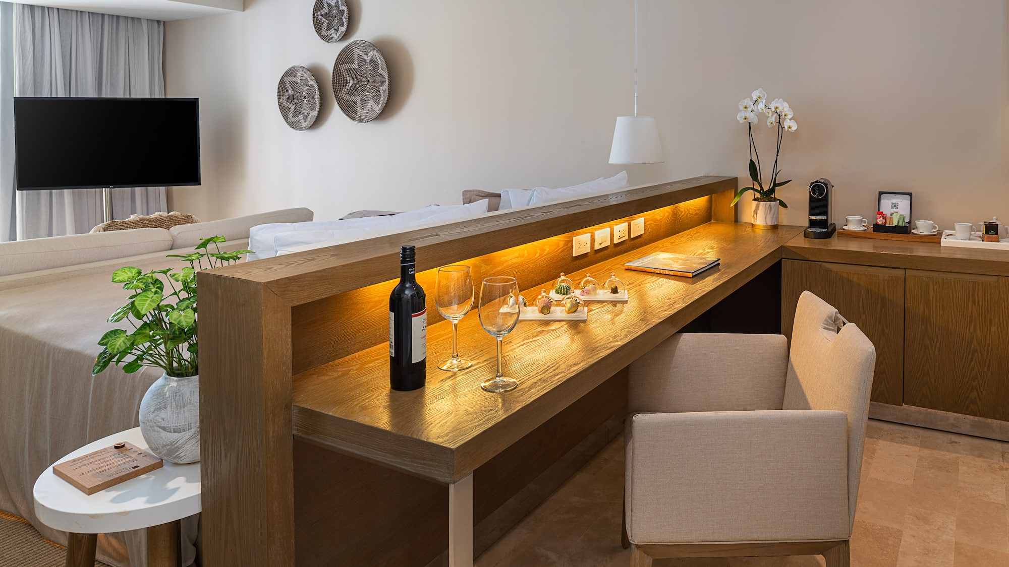 a table with wine glasses and a bottle on it