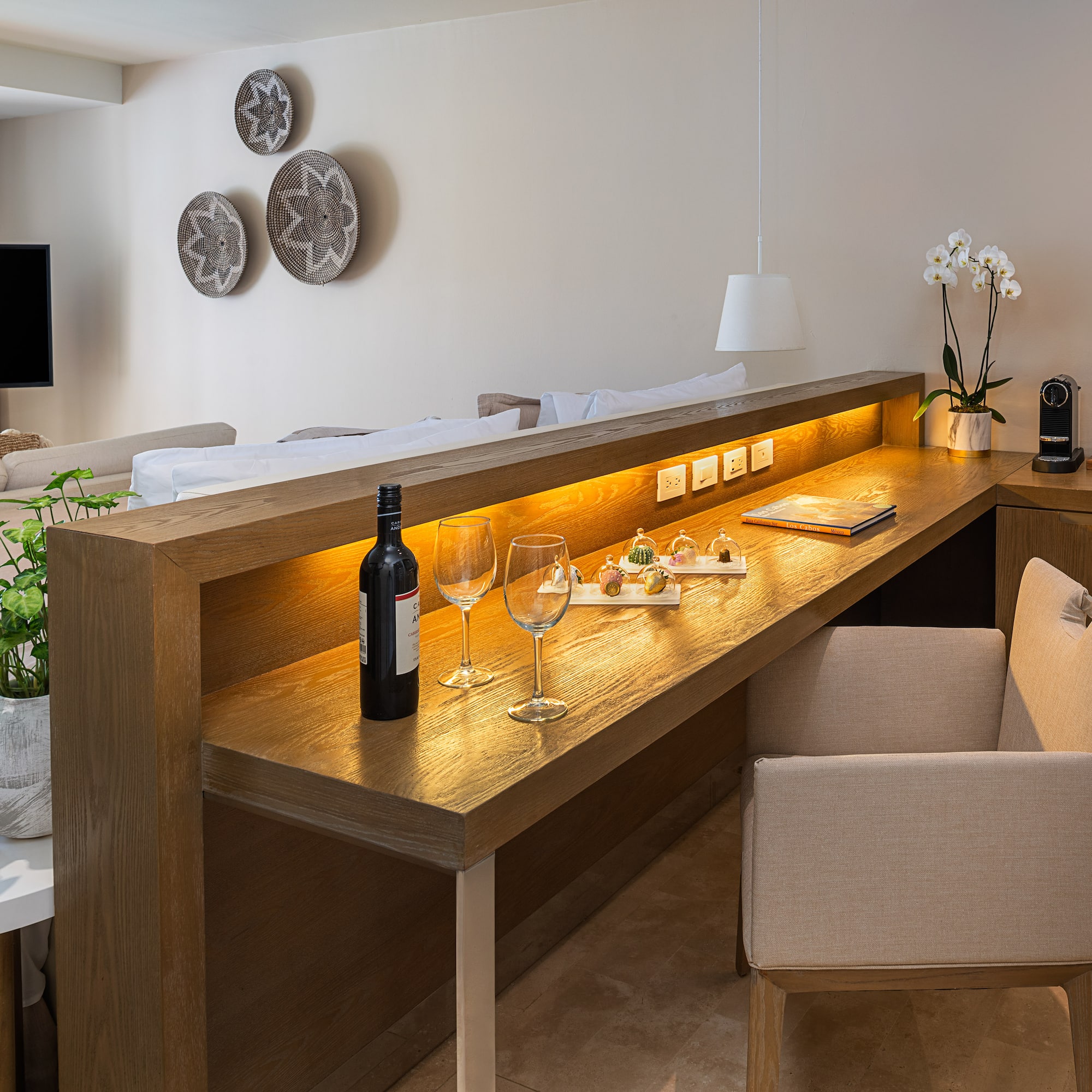 a table with wine glasses and a bottle on it