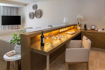 a table with wine glasses and a bottle on it