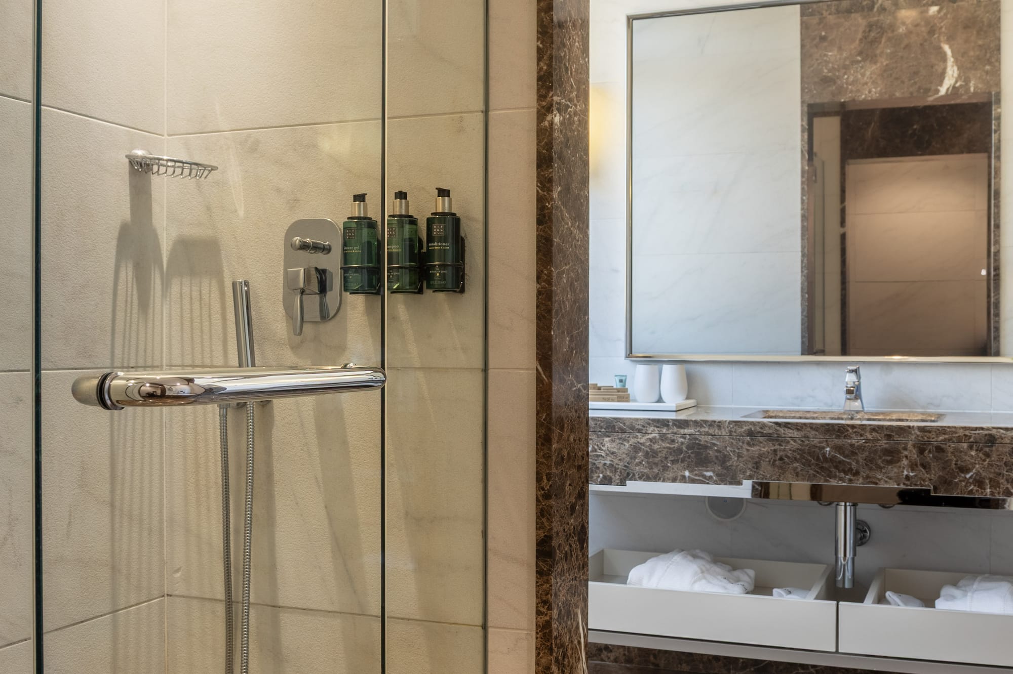 a bathroom with a glass shower door