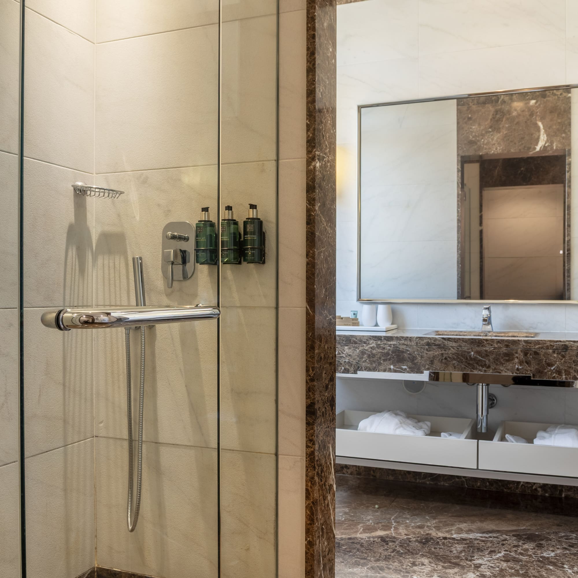 a bathroom with a glass shower door