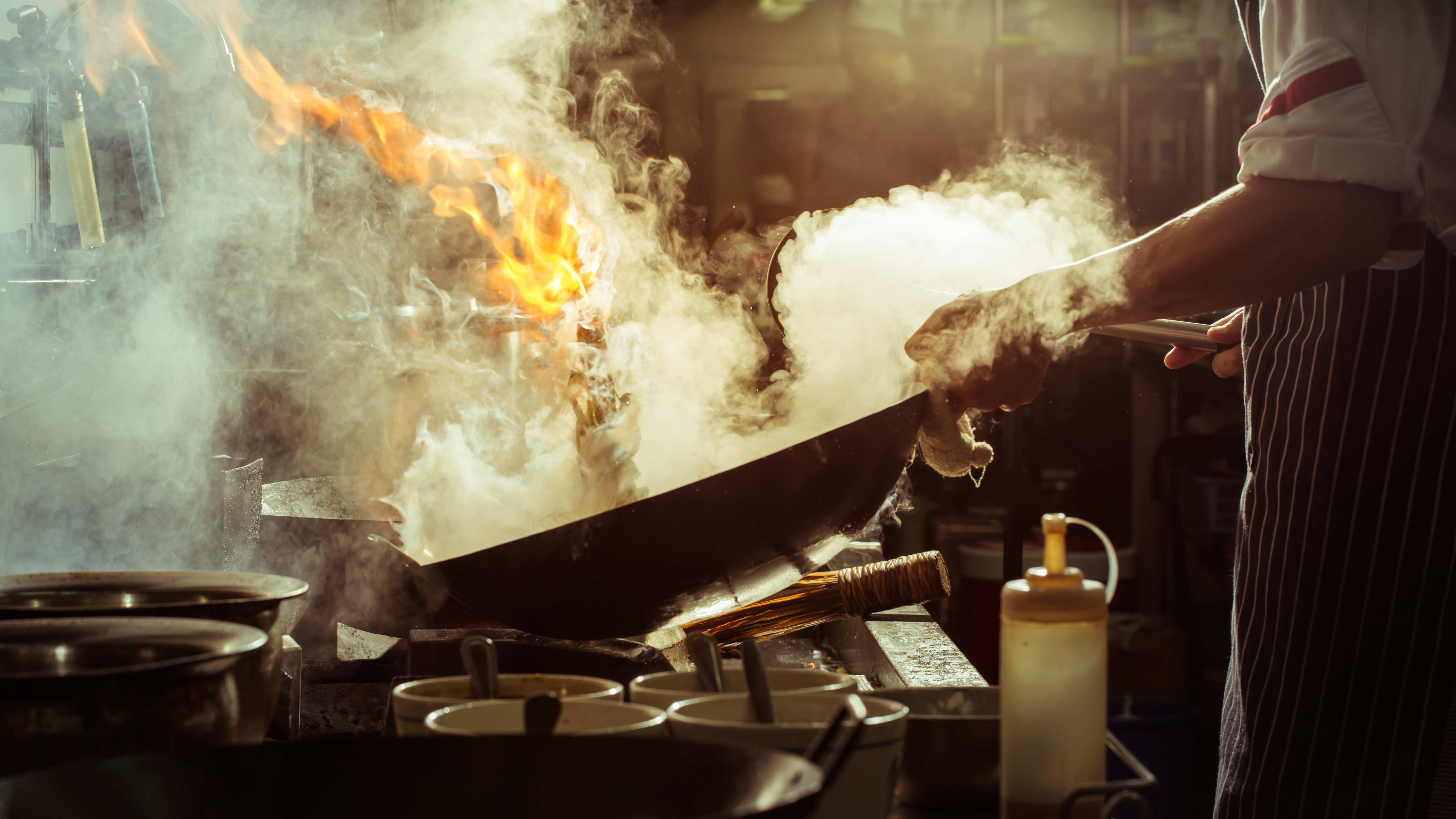 a person cooking in a wok