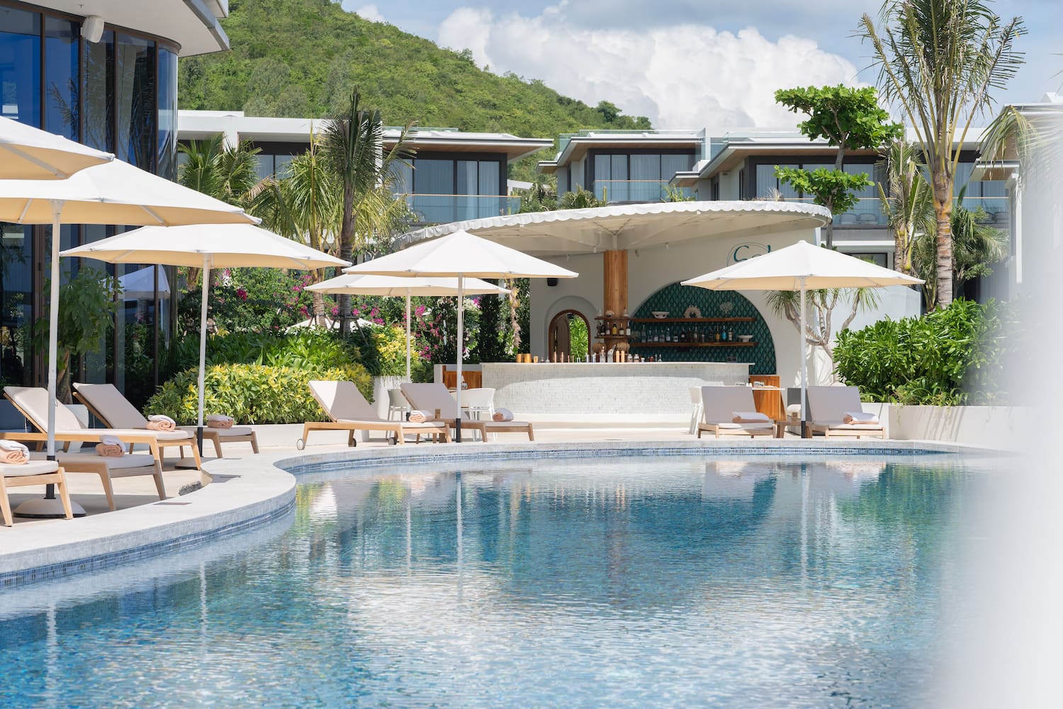 a pool with umbrellas and chairs