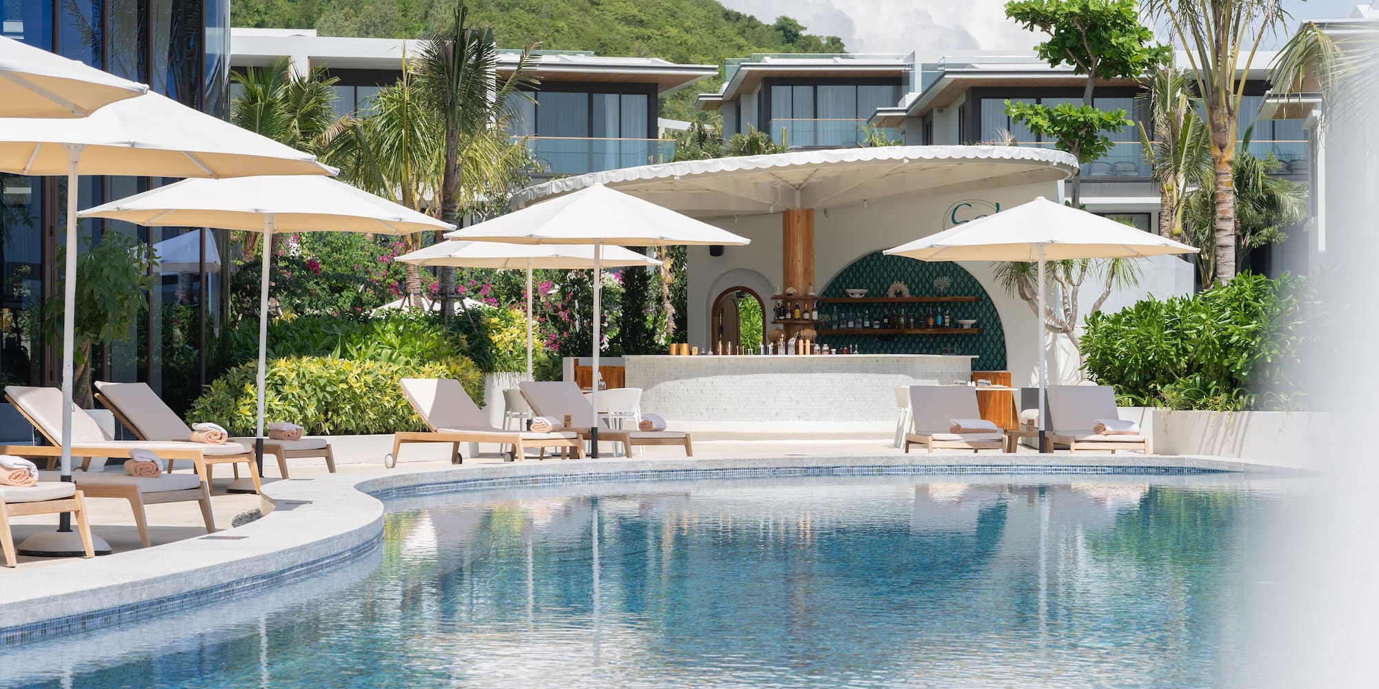 a pool with umbrellas and chairs
