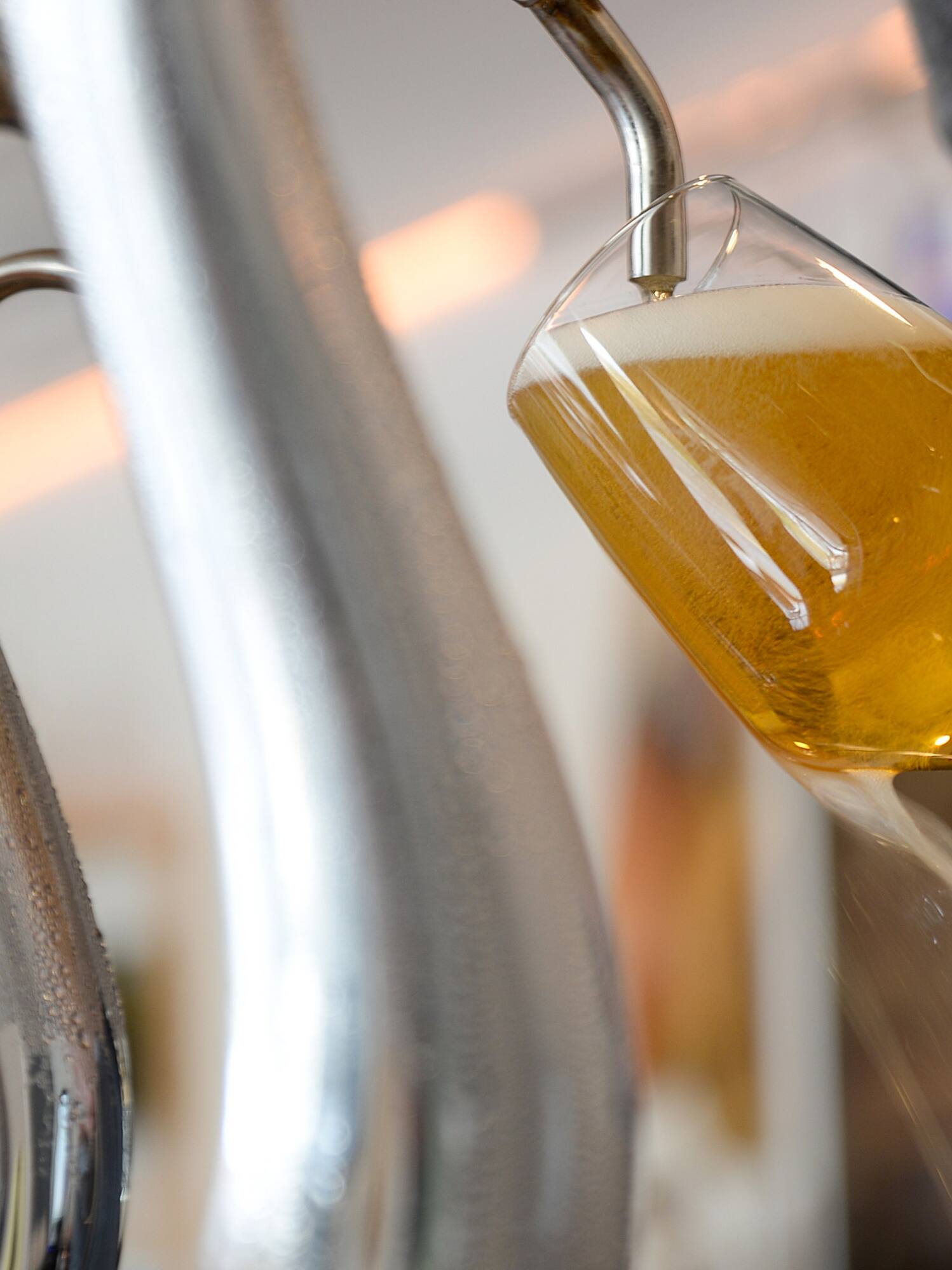a person pouring a glass of beer
