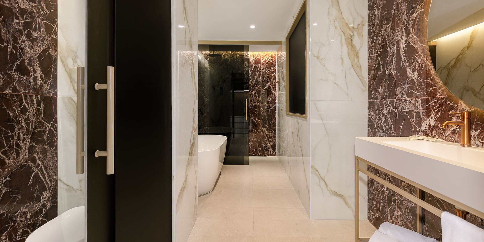 a bathroom with marble walls and a sink