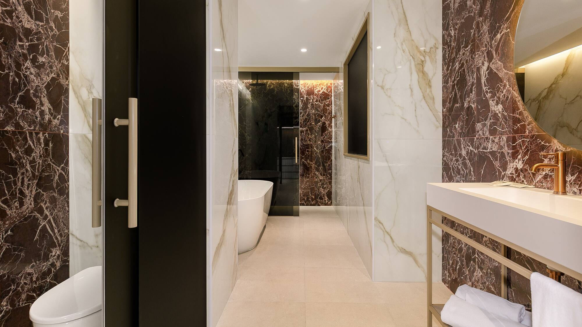 a bathroom with marble walls and a sink