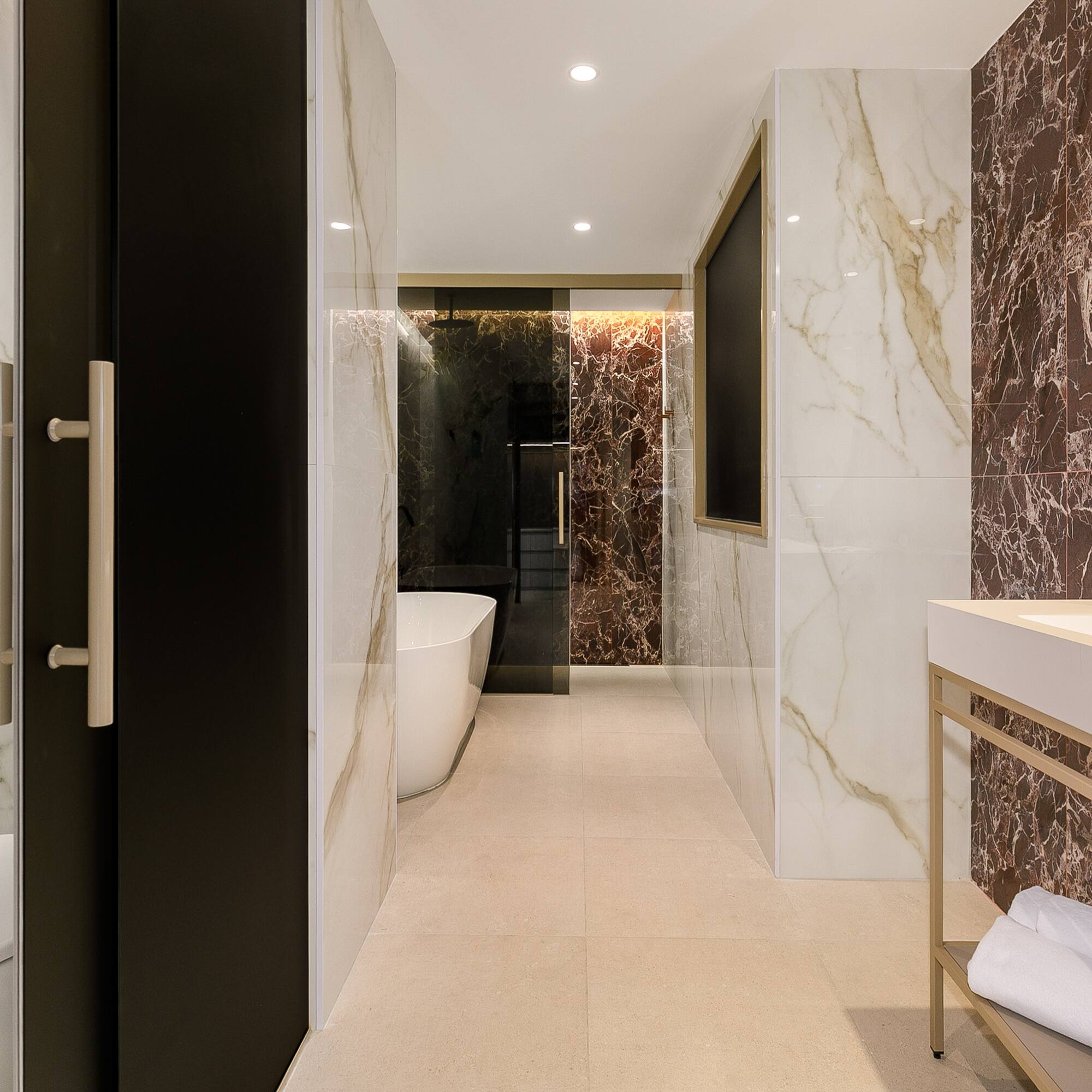 a bathroom with marble walls and a sink
