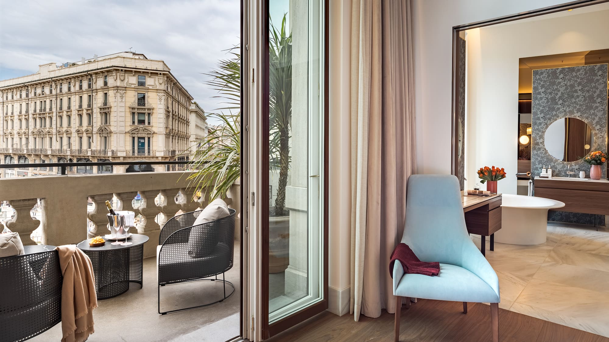 a room with a glass door and a chair and a table