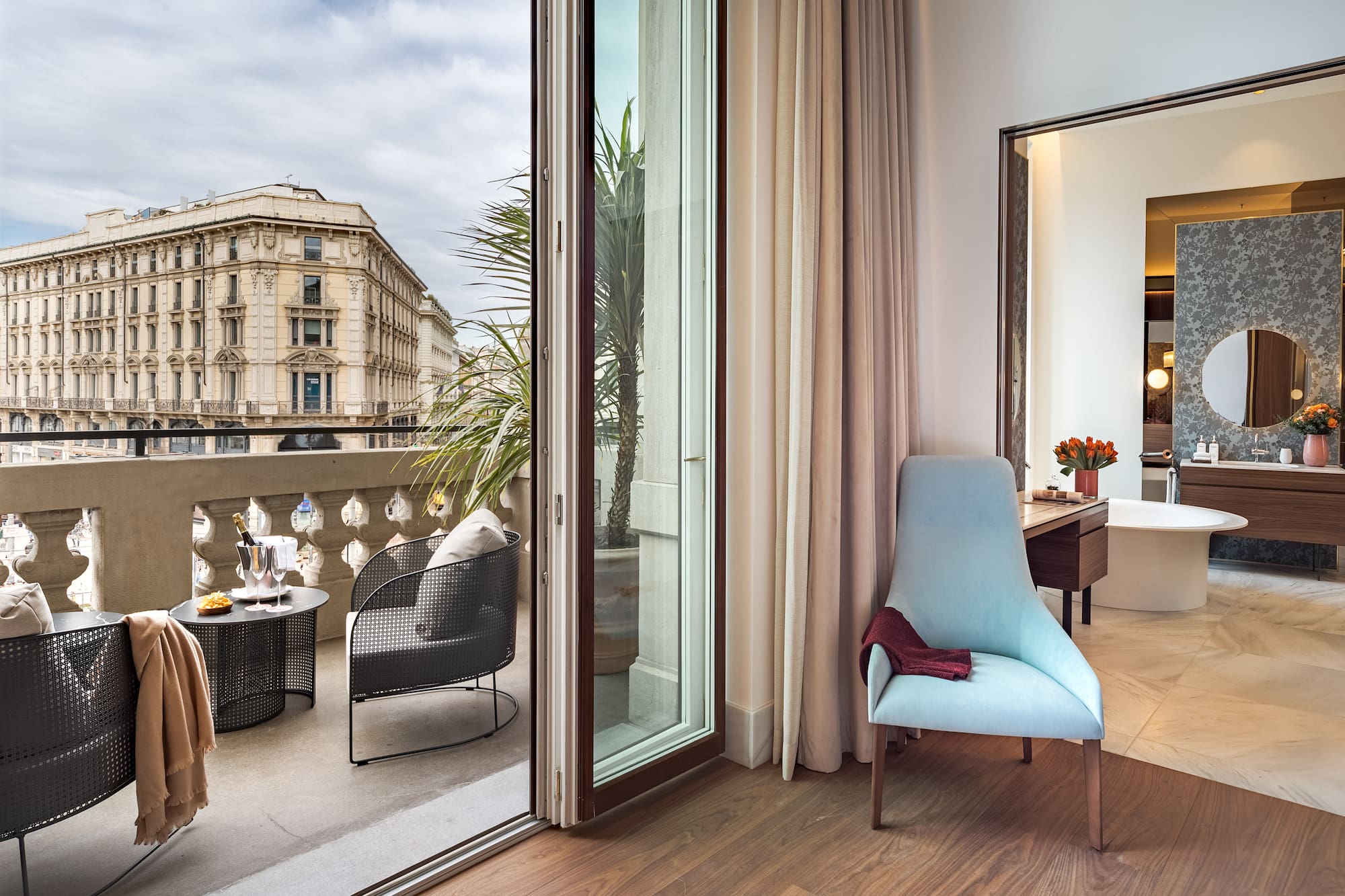 a room with a glass door and a chair and a table