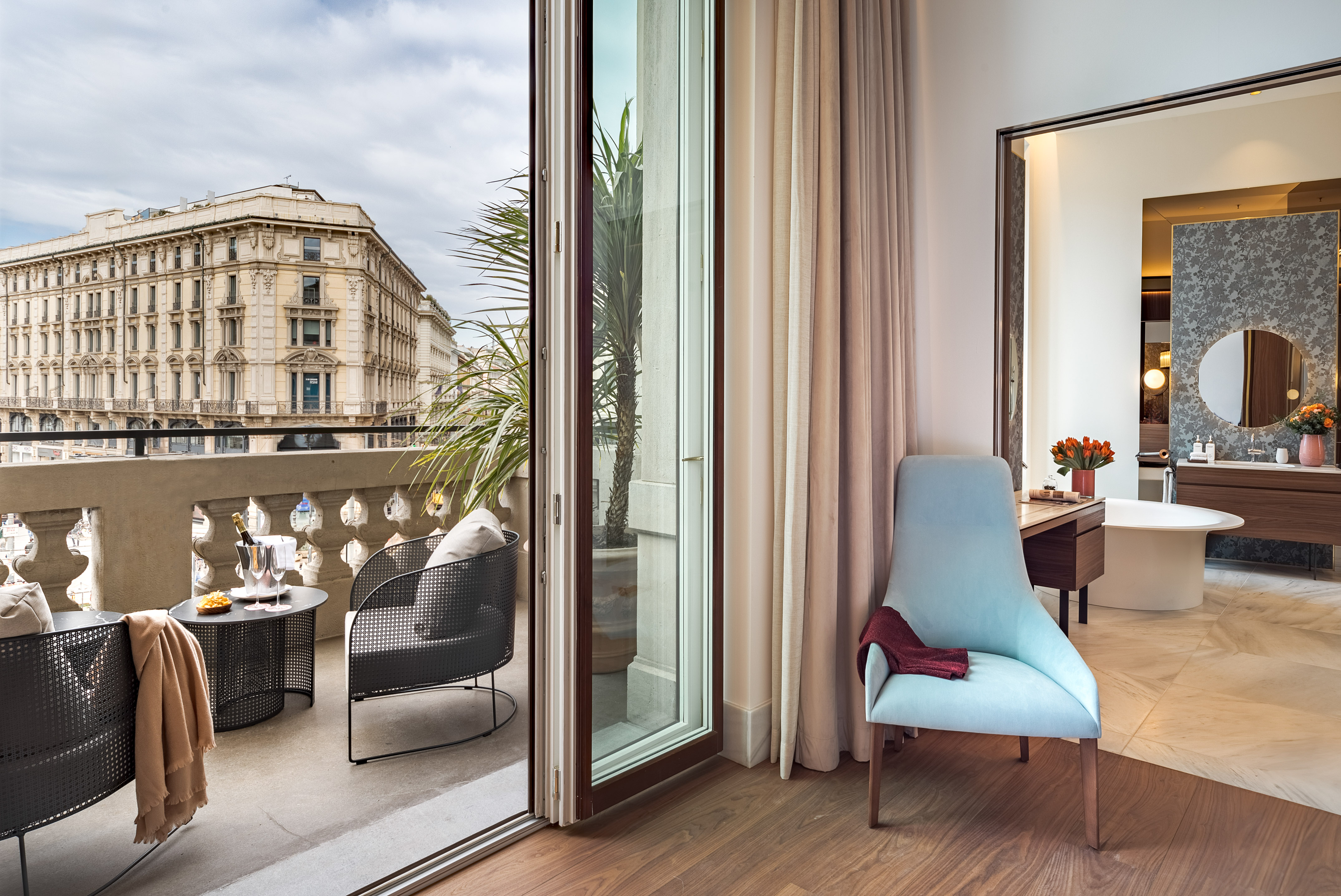 a room with a glass door and a chair and a table