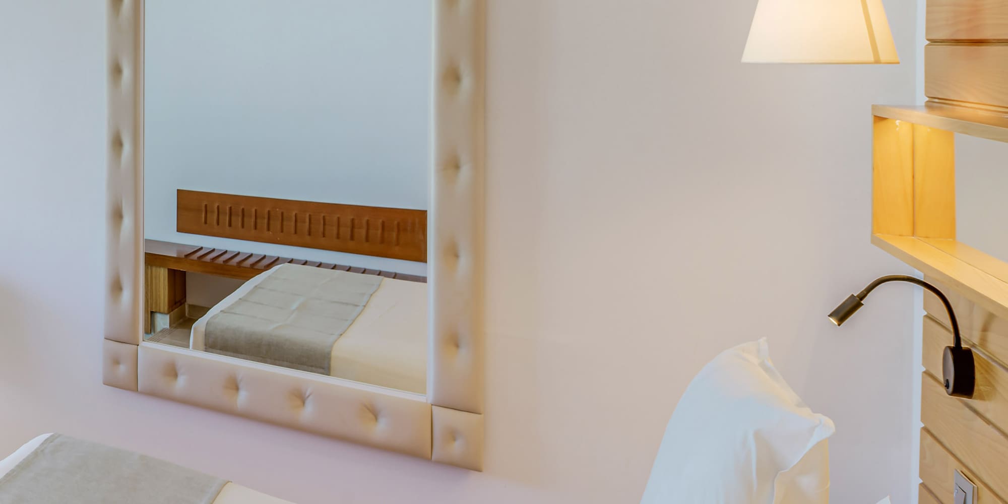 a mirror above a bed