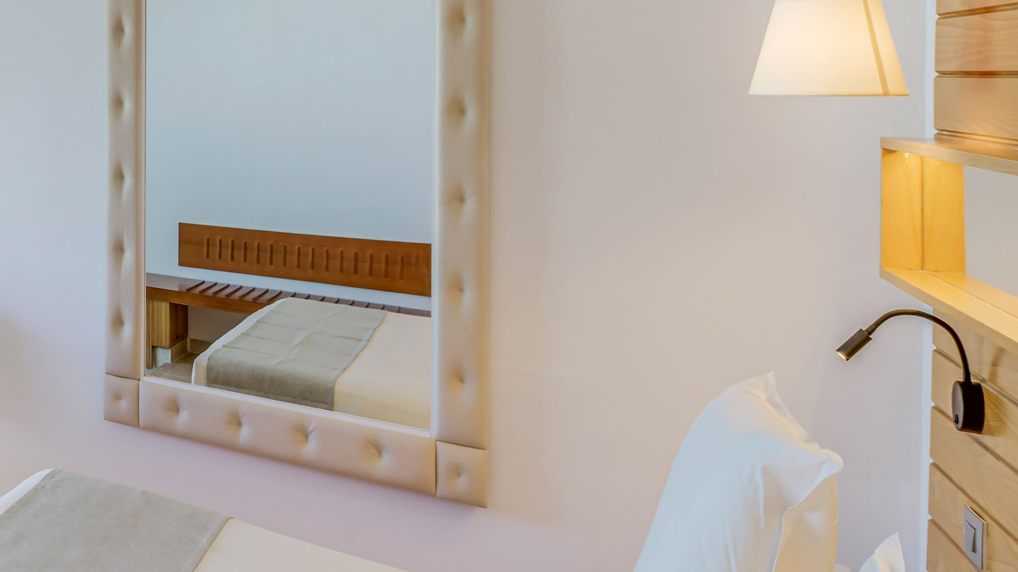 a mirror above a bed