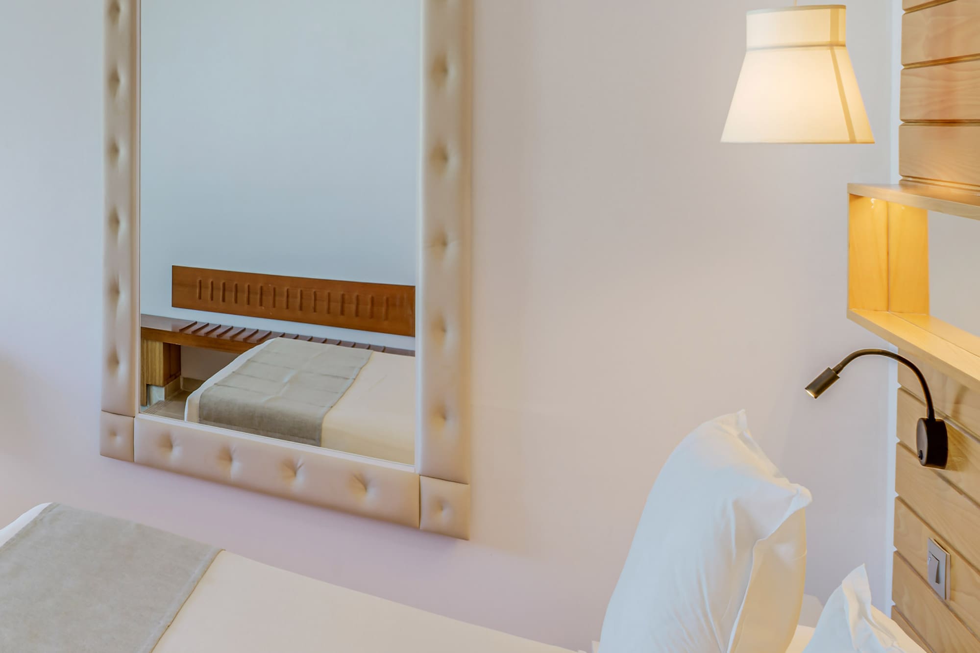 a mirror above a bed