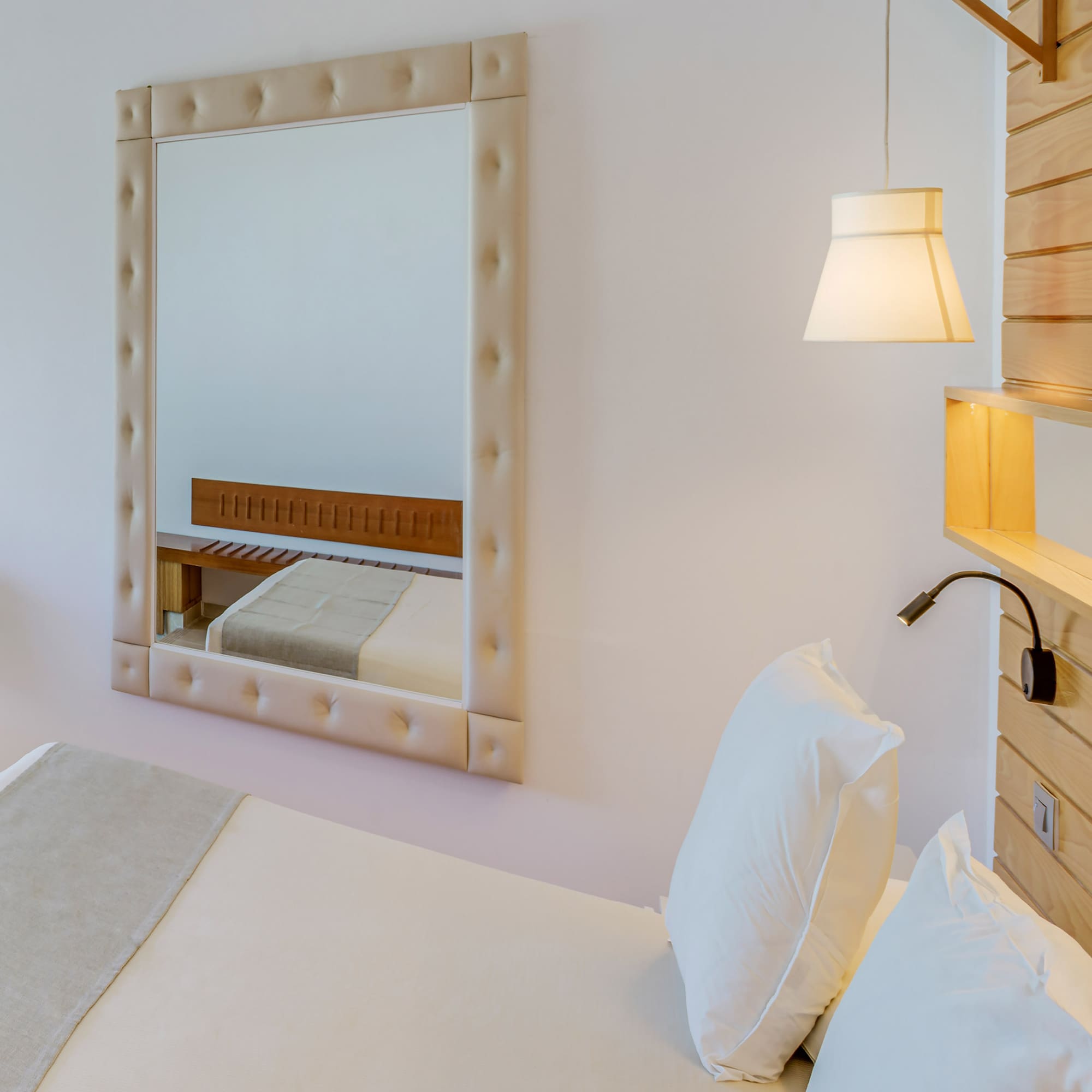 a mirror above a bed