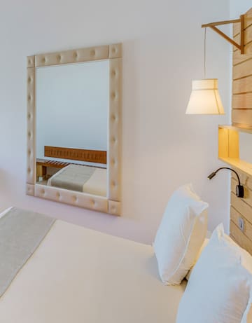 a mirror above a bed