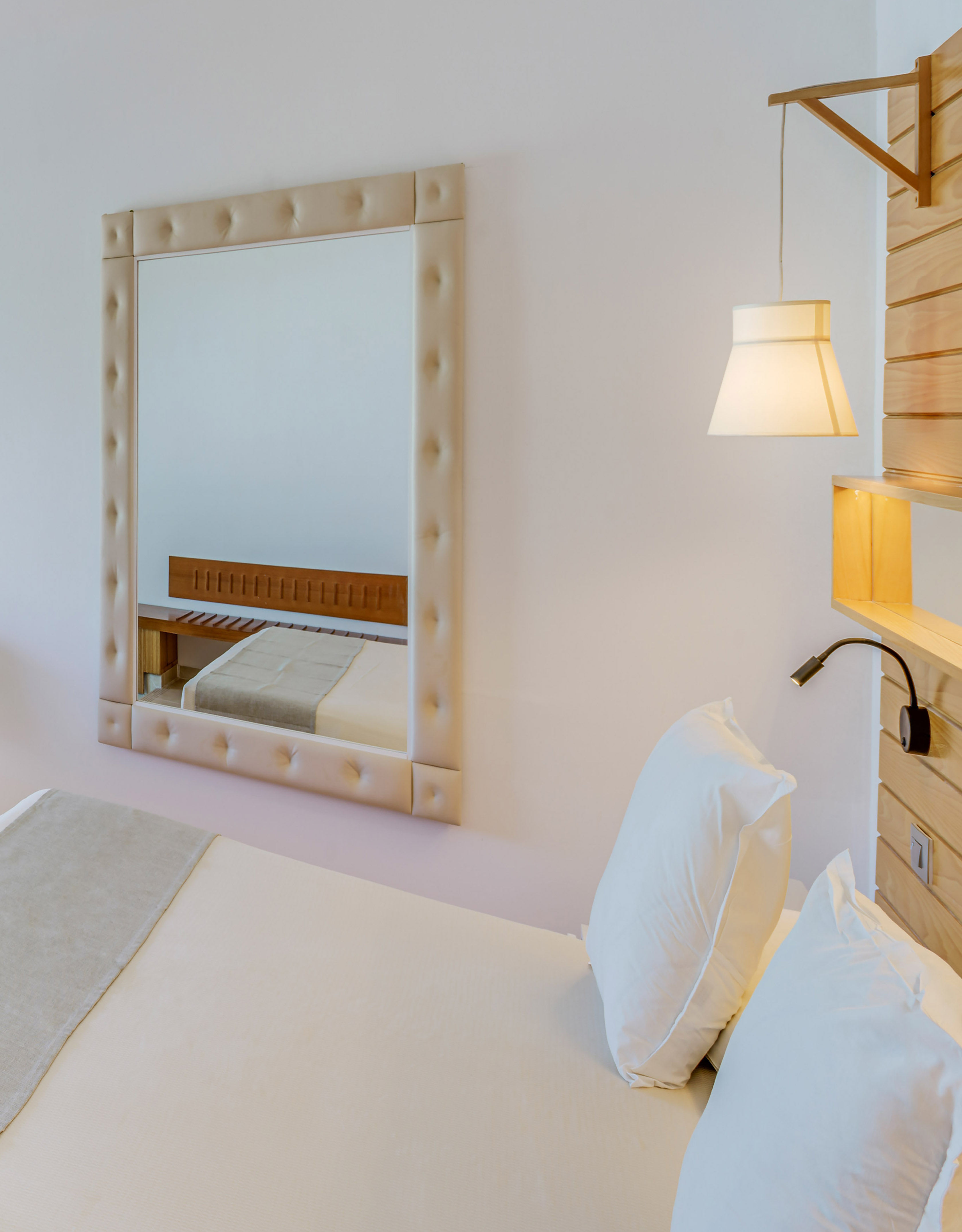 a mirror above a bed