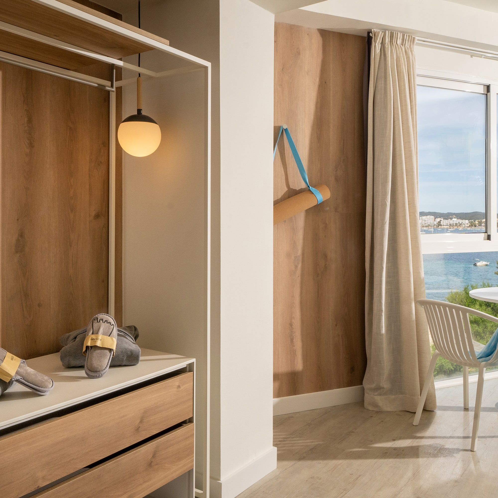 a room with a closet and a chair and a table