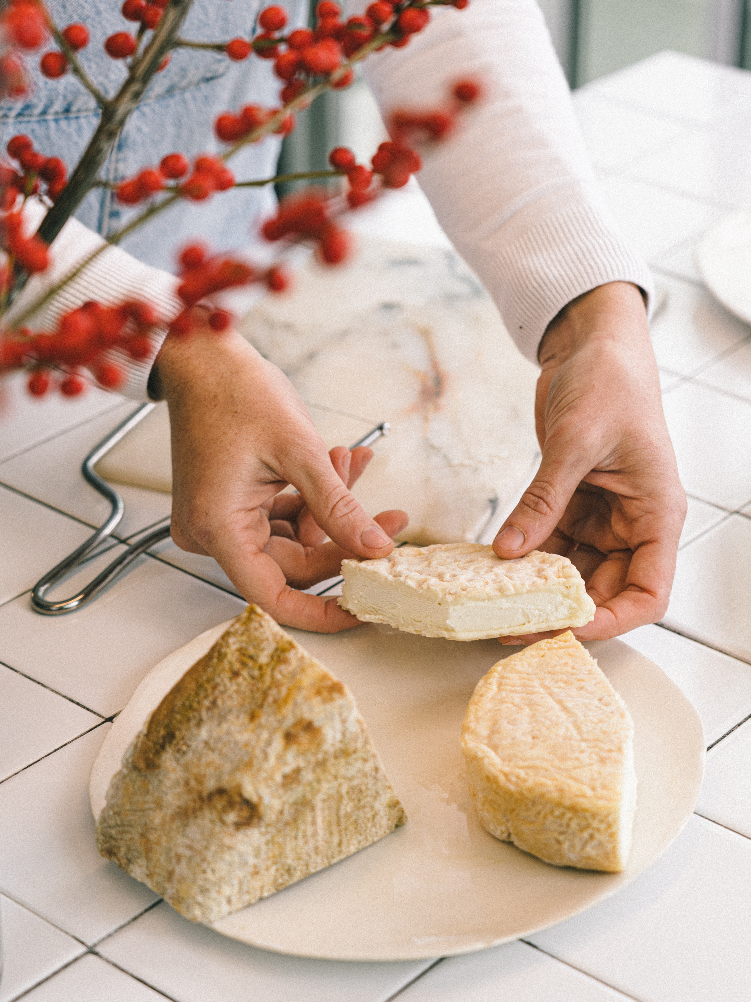 a person holding a piece of cheese