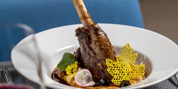 a bowl of food with a bone on the leg