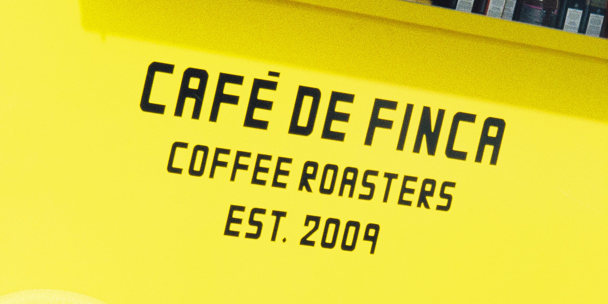 a yellow cart with black text and a wheel