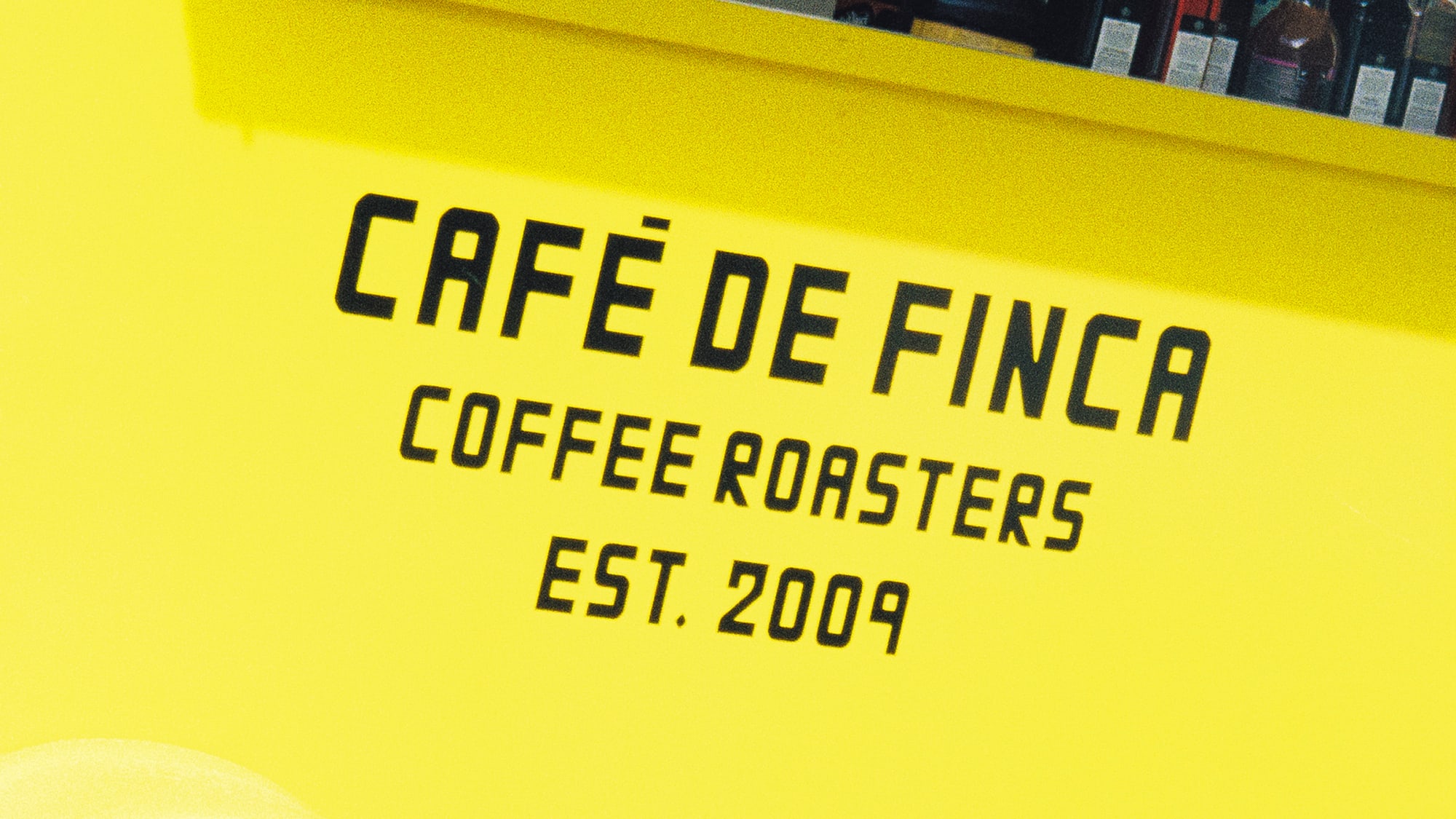 a yellow cart with black text and a wheel