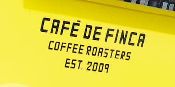 a yellow cart with black text and a wheel