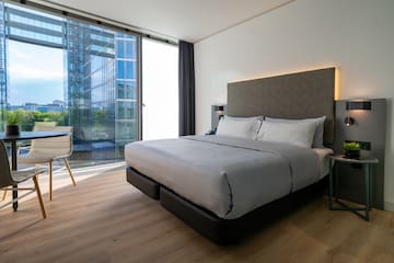 a bedroom with a large bed and a chair