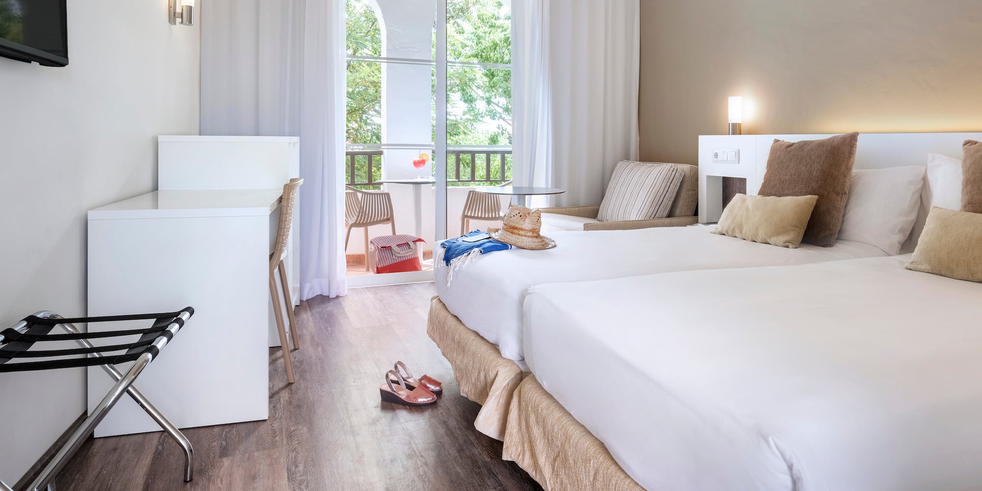 a room with two beds and a desk