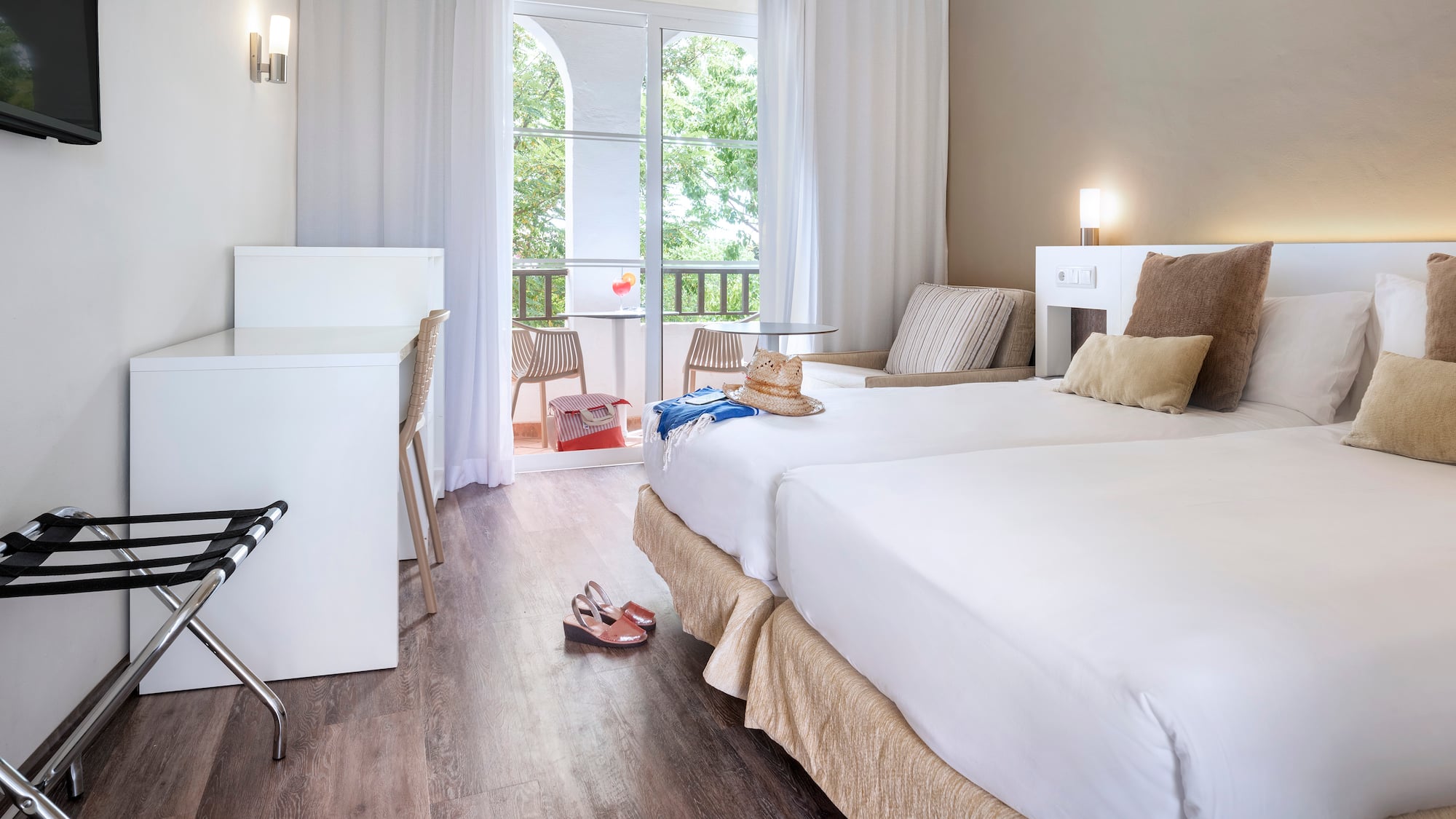 a room with two beds and a desk