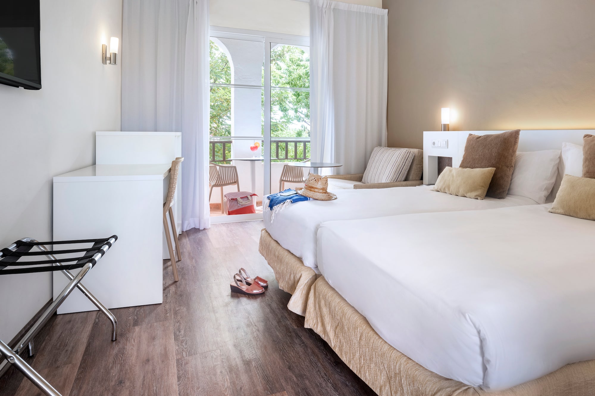 a room with two beds and a desk