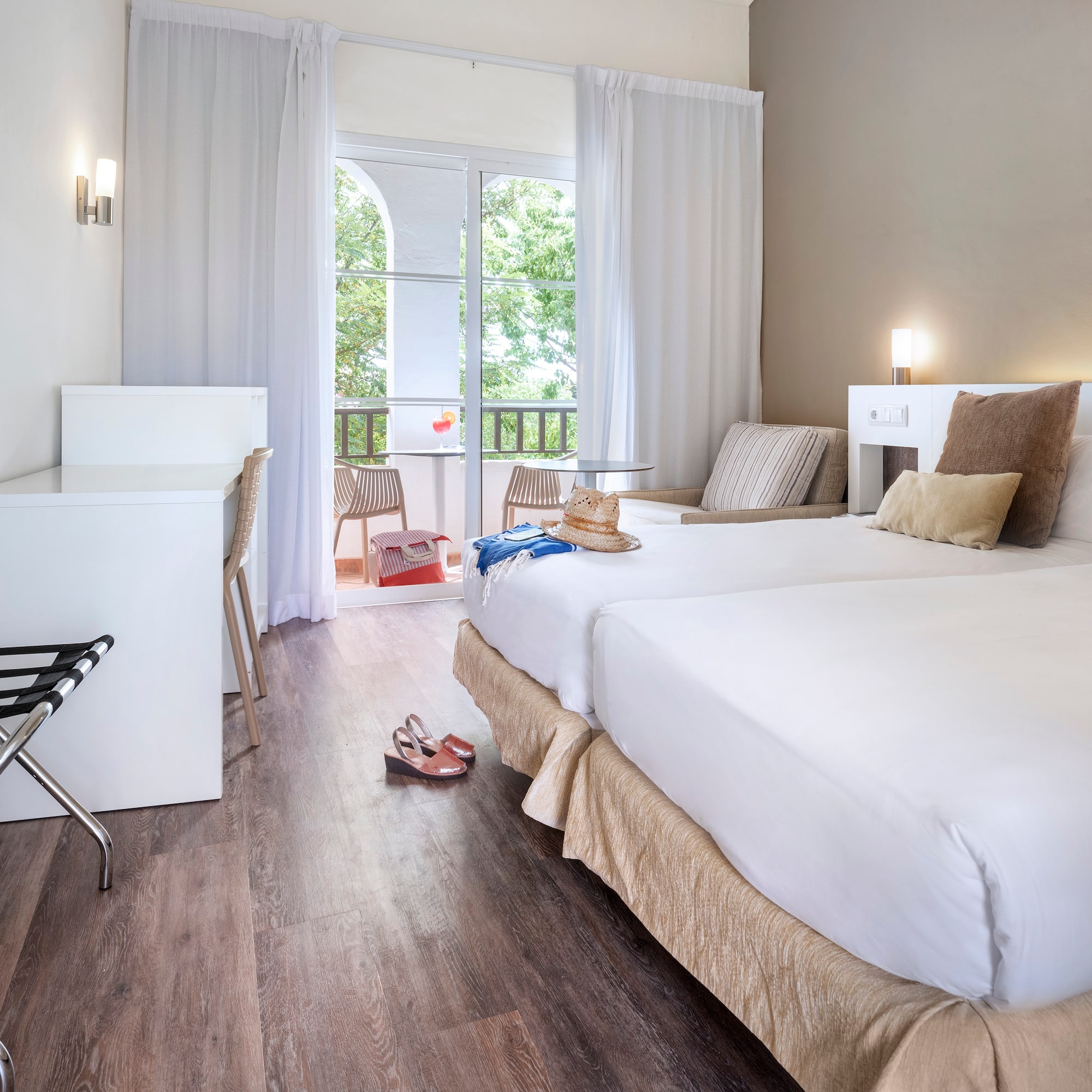 a room with two beds and a desk