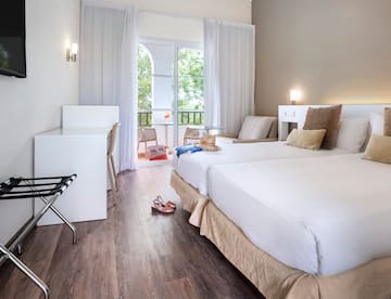 a room with two beds and a desk