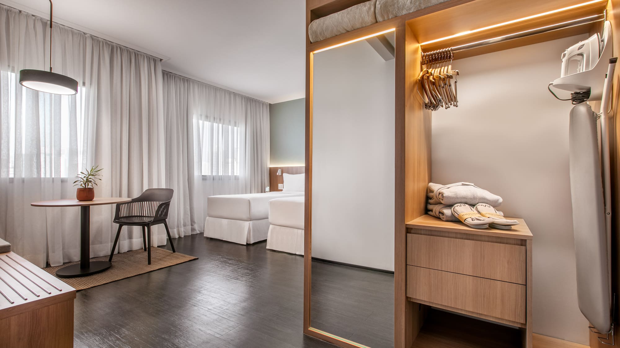 a room with a mirror and a table and chairs