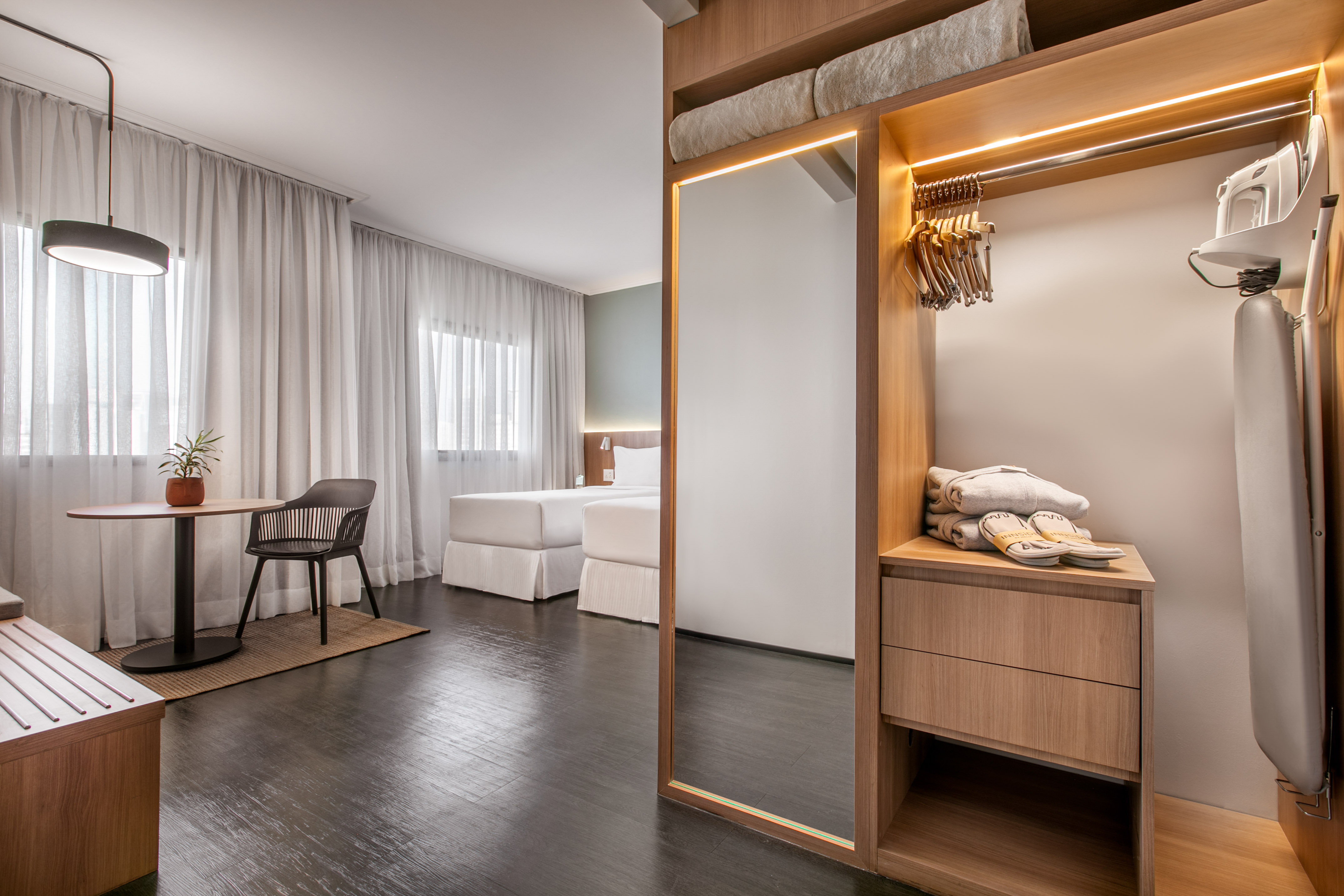 a room with a mirror and a table and chairs