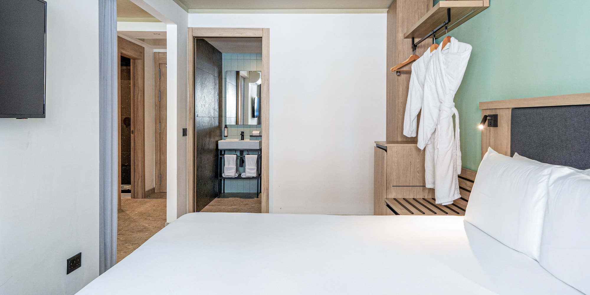 a white bed in a hotel room