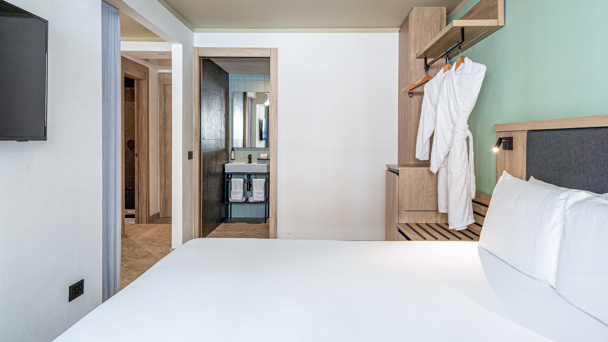 a white bed in a hotel room