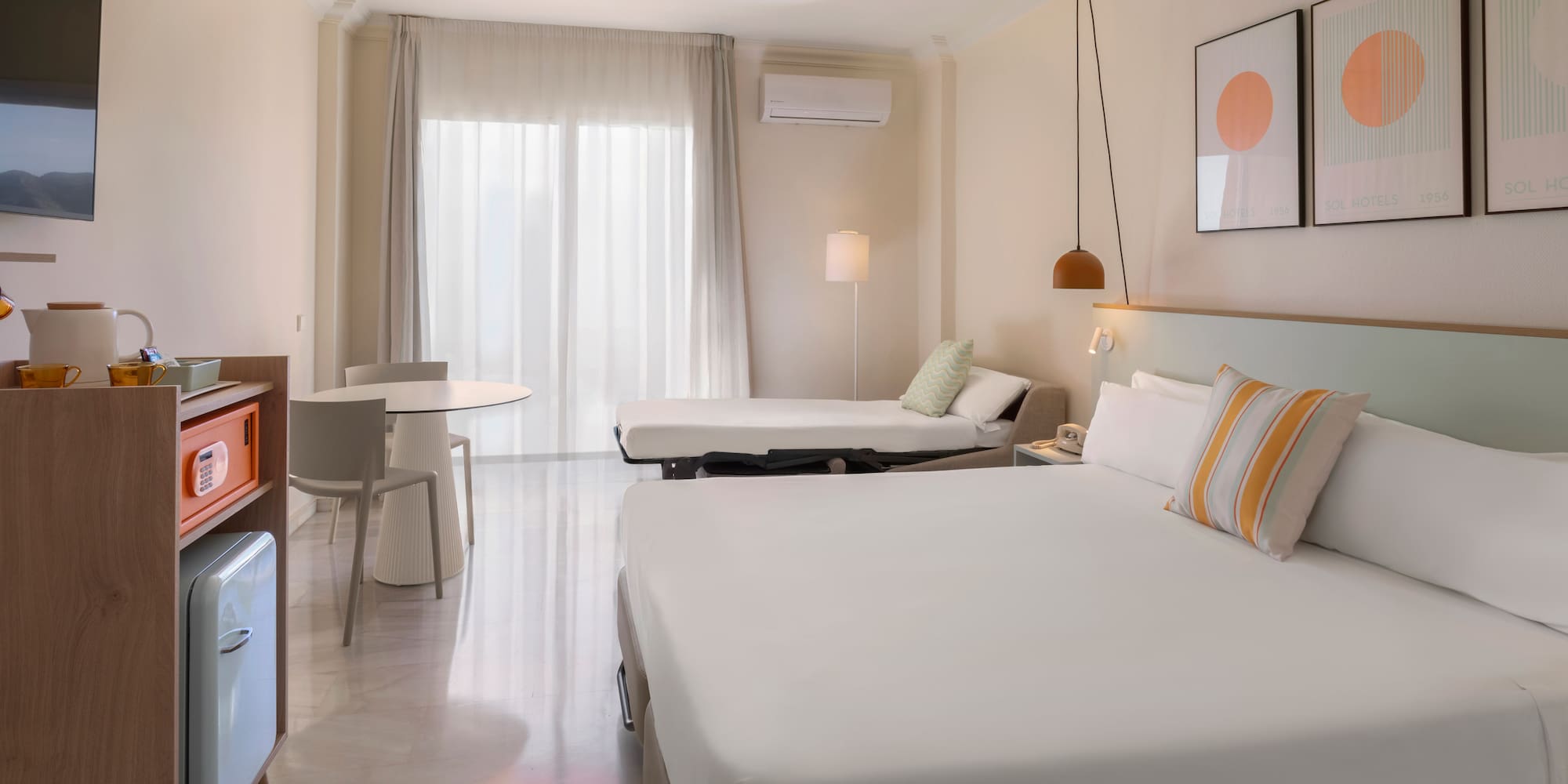 a room with a bed and a television